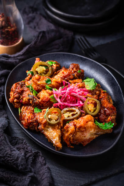 istock Grilled Lemon and garlic chicken wings with pickled root vegetables and jalapenos. 1492546069