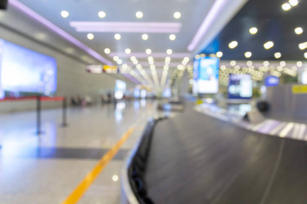 Blurred photo of waiting luggage delivery at the airport Blurred photo of waiting luggage delivery at the airport 機場離境區 stock pictures, royalty-free photos & images