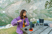 Woman brewing coffee in nature