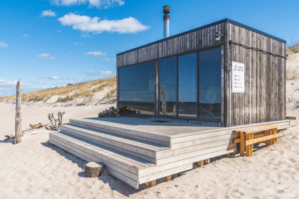 istock Beautiful modern wooden sauna on a white sandy beach for renting 1492552766