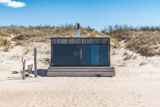 istock Beautiful modern wooden sauna on a white sandy beach for renting 1492552770