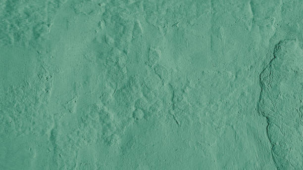 istock Stucco plaster wall background texture of green painted cement, concrete wall 1492552853