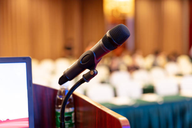 istock Microphone and laptop on podium waiting for presentation to start 1492552930