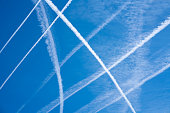 detail of chemtrails in the blue sky