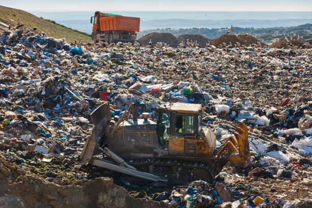 istock Heavy machinery shredding garbage in an open air landfill. Pollution 1492560057