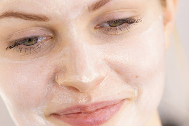 istock Girl with cream moisture cosmetic on face 1492560391