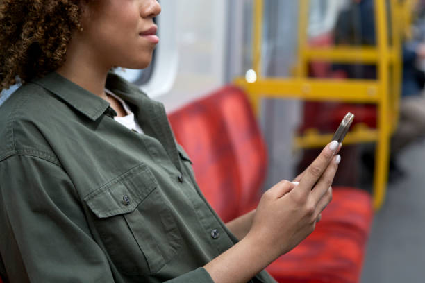istock Unrecognizable woman traveling by underground and browsing a mobile phone 1492564667