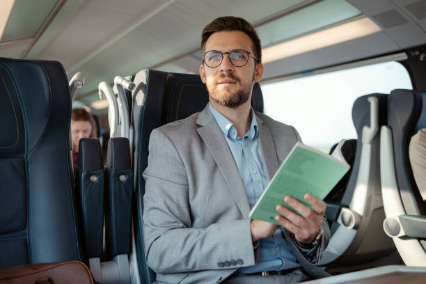 istock Traveler with Book in Train 1492564767