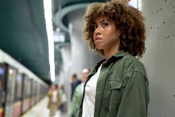 istock Young afro woman standing on platform and waiting for the underground 1492565667