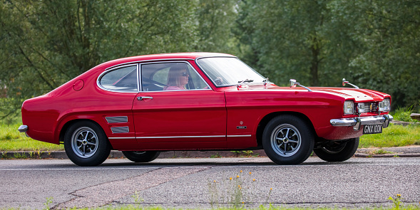 Stony Stratford, Bucks, UK Aug 29th 2021. 1972 red FORD CAPRI   classic car travelling on an English country road