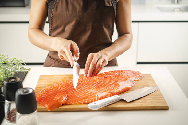 istock Women hold a raw salmon fillet 1492567678