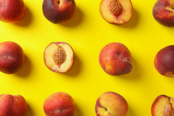 istock Fresh ripe peach fruits on yellow background 1492567821