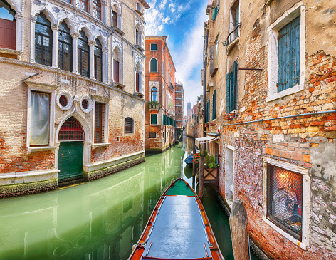 Gorgeous cityscape of Venice with narrow canals, boats and gondolas and bridges with traditional buildings. Location: Venice, Veneto region, Italy, Europe