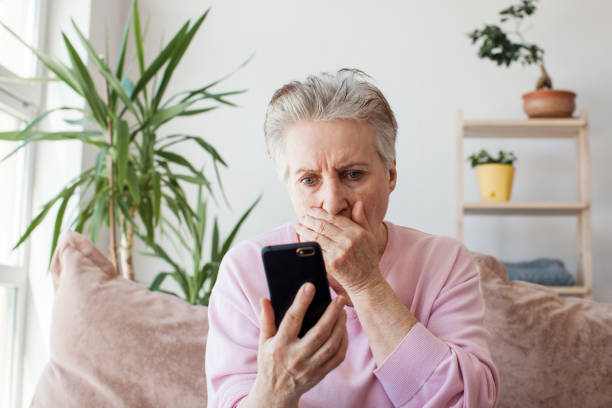 istock Unhappy stressed mature middle aged woman looking at phone screen 1492569880