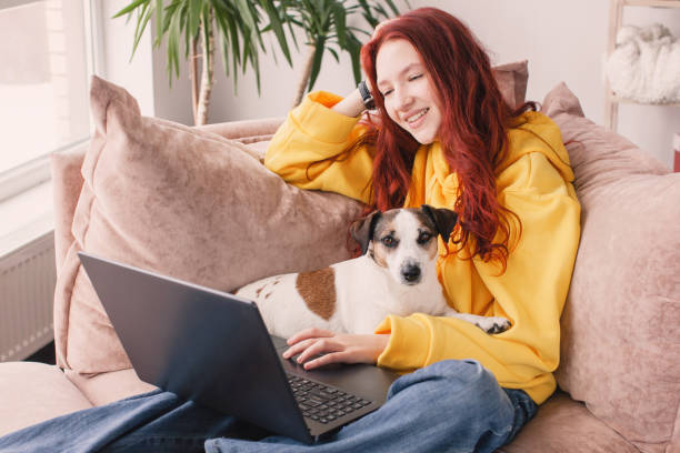 istock Relaxing young woman using laptop in living room 1492571295