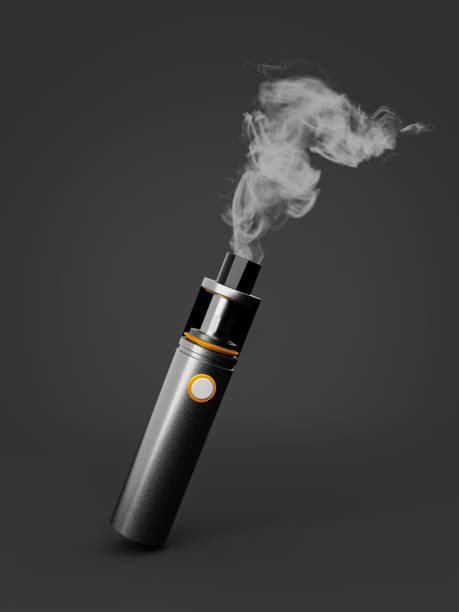 Electronic cigarette with vapor against gray background stock photo