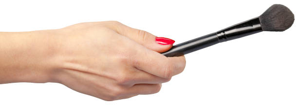 istock woman hand holding face brush 1492573409