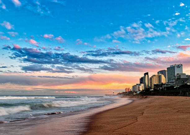 Umhlanga Rocks Beach at Sunset Umhlanga Rocks Beach with buildings at sunset zululand stock pictures, royalty-free photos & images