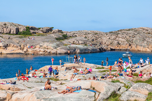 Smögen, Sweden-July, 2018: People sunbathing on the rocks by the sea