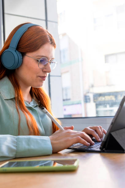 istock Redhead Girl. Caffeinated Productivity: Beautiful Redhead Excelling in Remote Work 1492579038