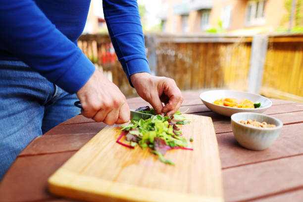 istock Close up of chef cooking vegetables on cutting board 1492580022