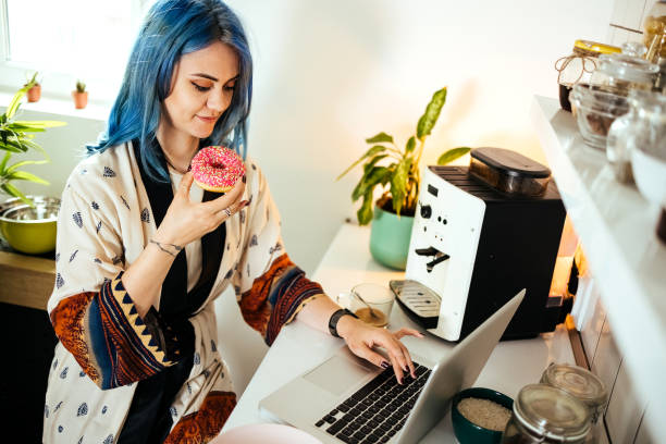 istock Woman works on a laptop in the kitchen 1492581896