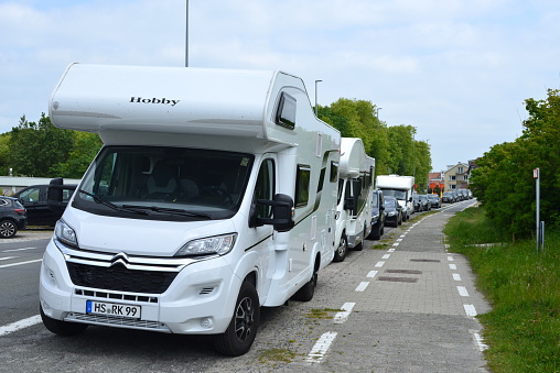 De Haan aan Zee, West-Flanders, Belgium - May 21, 2023: foreigners knows about free parking. Stationary Citroën Hobby motor home from Germany Mönchen Gladbach next to roadside asphalt bicycle lane