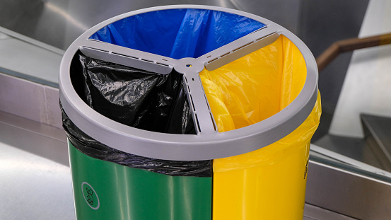 Small black yellow green compartment waste disposal bags environmental airport interior