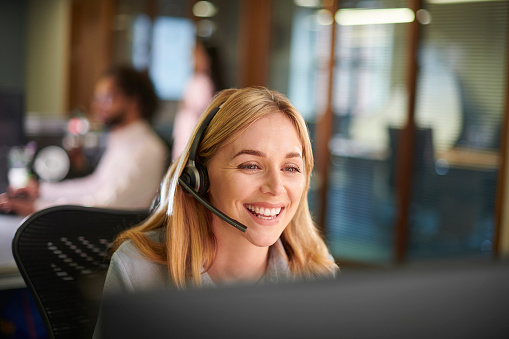 Student sitting at the computer room wearing headset at the university