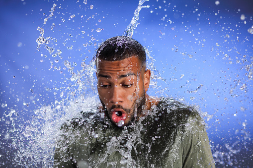African-american man after splash of water for sides.