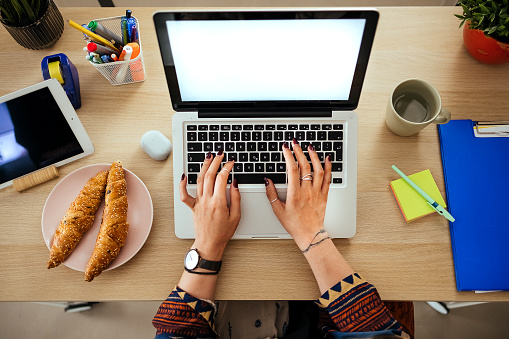 Woman working on laptop from home