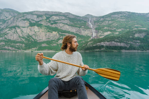 istock Man canoeing on the background of the waterfall 1492586060