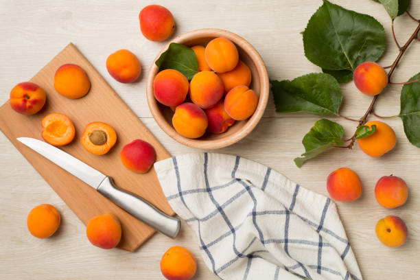 istock Composition with ripe apricots on wooden background, top view 1492586086