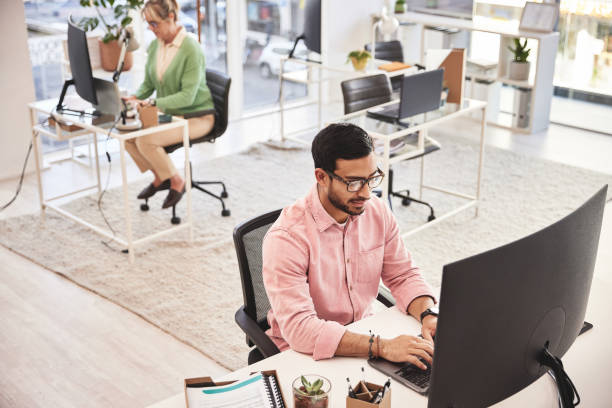 istock Information technology, businessman with glasses and computer in a creative startup and office. Man and programmer reading online code for software development 1492586436