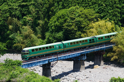 Kokonoe-machi, Oita, Japan - May 21, 2023 : KIHA 71 Limited express “Yufuin no Mori” crossing the Narukogawa Bridge