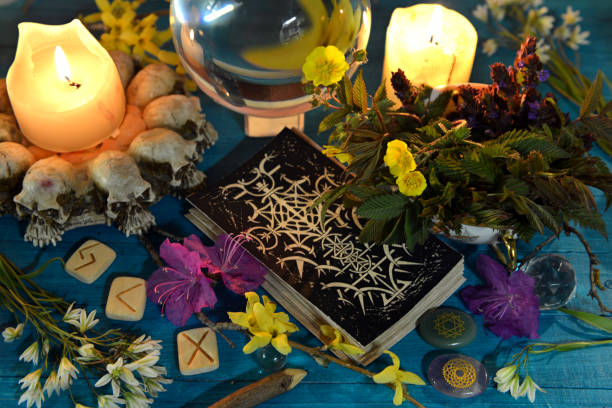 istock Tarot cards, candles, runes and magic ball on ritual altar table. Occult, esoteric and divination still life. Mystic background with vintage objects 1492589811