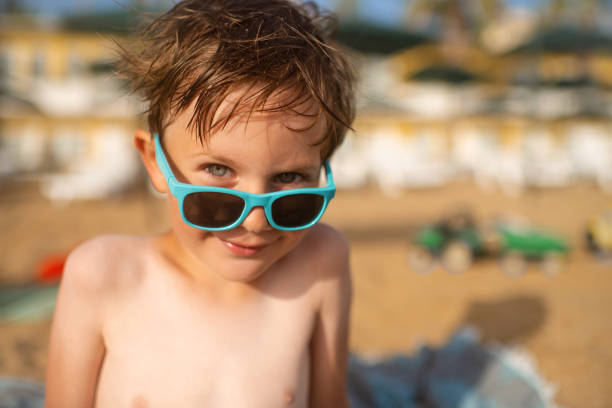 Little boy near the sea on beach holidays