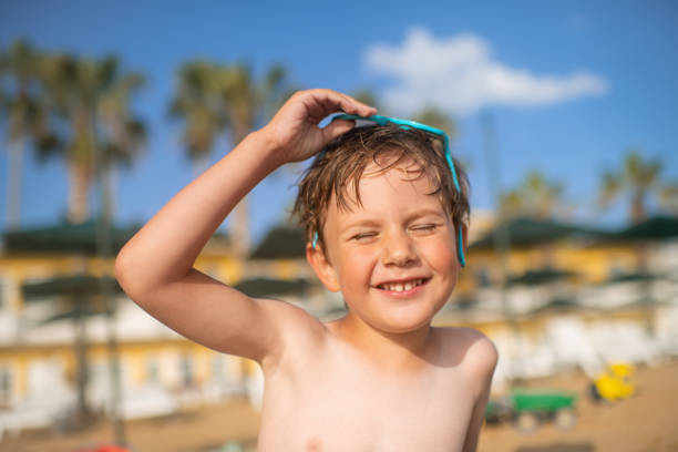 Little boy near the sea on beach holidays