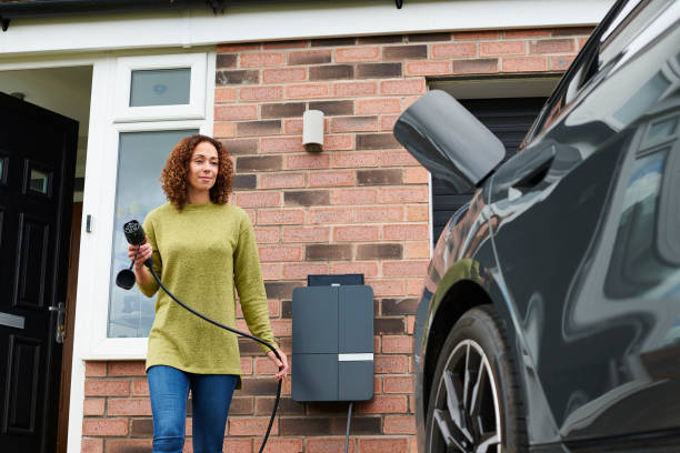 istock homeowner charging electric car on driveway 1492589851