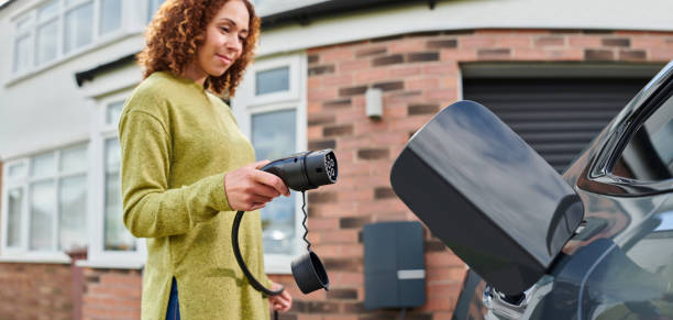 istock homeowner charging electric car on driveway 1492590827