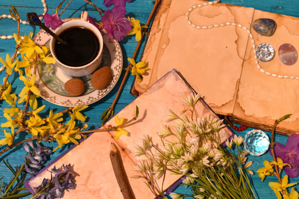 istock Old cup with chocolate candies, crystals and open books. Occult, esoteric and divination still life. Mystic background with vintage objects 1492590992