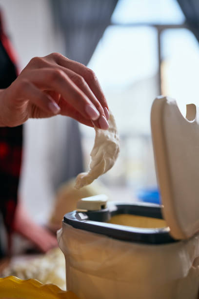 istock Female hand throwing food leftovers in a bokashi container for fermentation. Housewife recycling organic waste in a domestic compost bin 1492592610