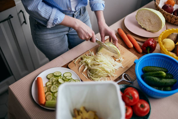 istock The cook preparing vegetables and recycling organic leftovers in a compost bin. Responsible female person leading a healthy and sustainable lifestyle 1492592995