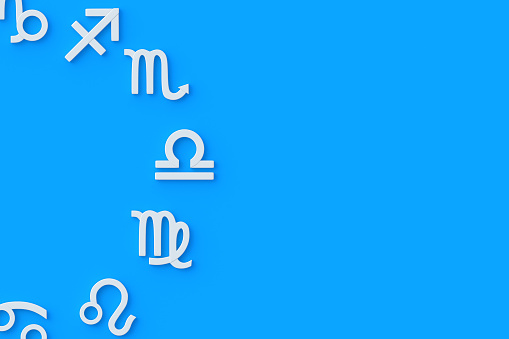 Astrological signs on blue background. Metallic golden zodiac symbol. Horoscope and numerology. Astrological calendar. Top view. Copy space. 3d render