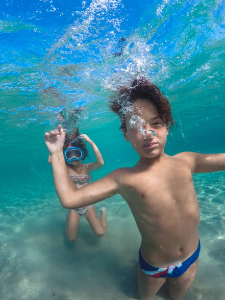 istock Boy having fun diving underwater on his summer vacation 1492597045