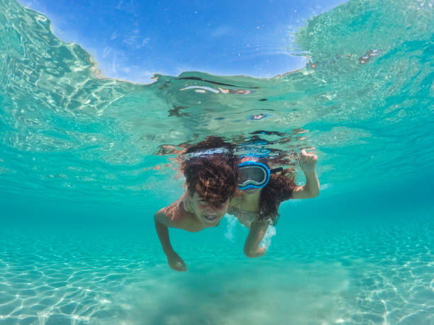 istock Children having fun diving underwater on their summer vacation 1492597103