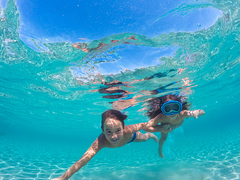 Portrait of a young girl swimming underwater