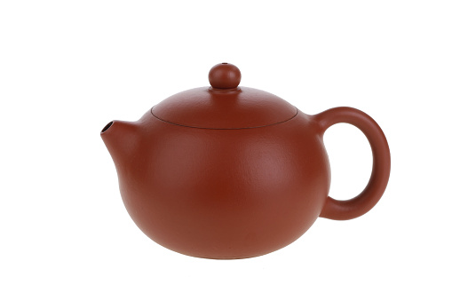 Dark-red enameled pottery teapot on white background