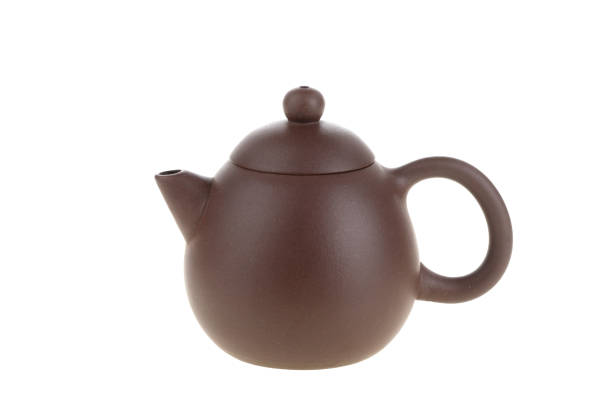 istock Dark-red enameled pottery teapot on white background 1492597514