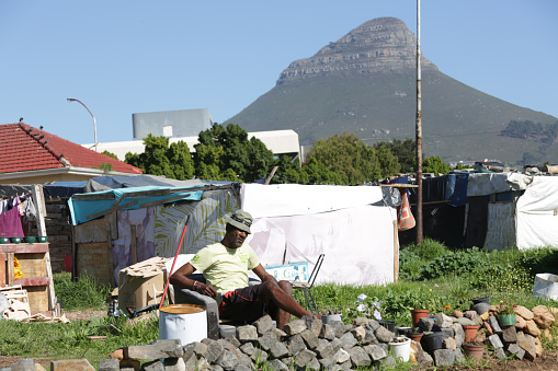 Cape Town, 3 May 2023. In South Africa, illegal shacks have become increasingly common due to unemployment and poverty. These makeshift homes, known as homeless shack houses, are constructed on vacant land in District Six, a mere few kilometres away from the city canter.\n\n\n\n\nIn South Africa, illegal shacks have become increasingly common due to unemployment and poverty. These makeshift homes, known as homeless shack houses, are constructed on vacant land in District Six, a mere few kilometers away from the city center.